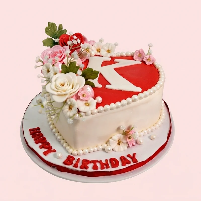 Red and white heart shaped birthday cake with sugar roses and monogram by Cakeville Scarborough