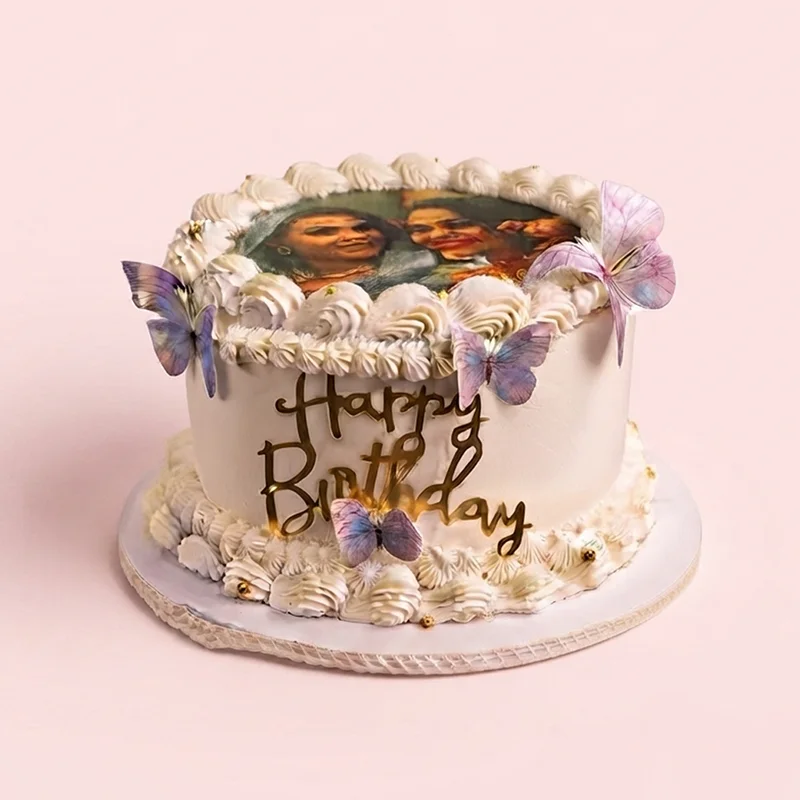 White cream birthday cake with edible photo topper and pastel butterflies by Cakeville Scarborough