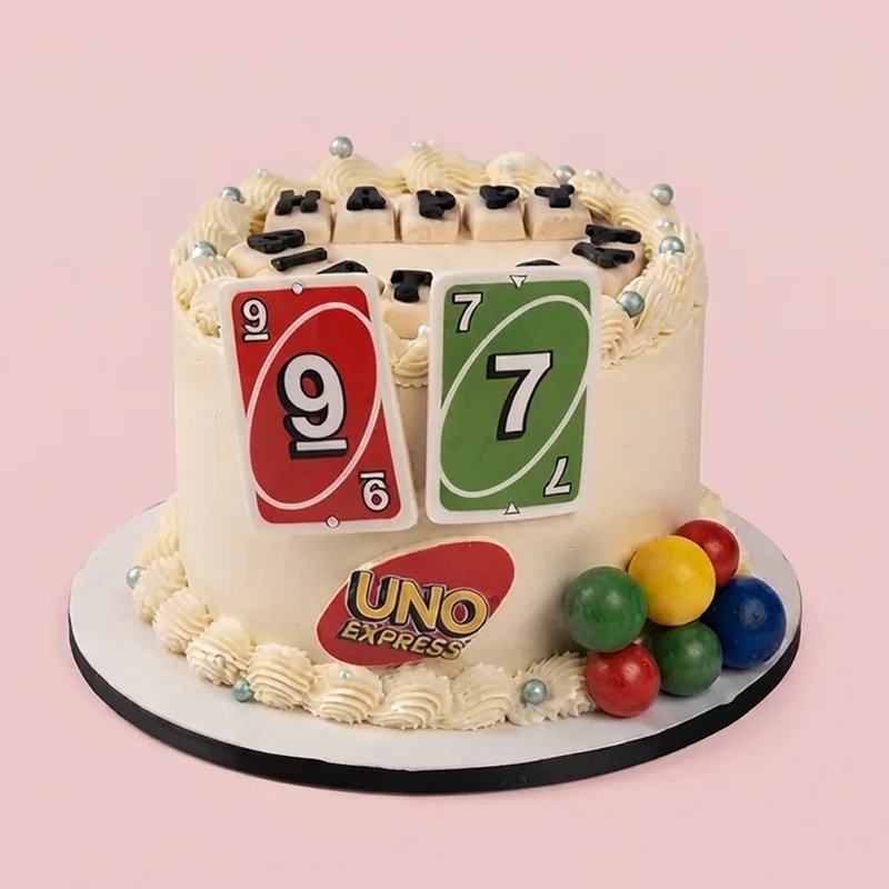 Cream card game themed birthday cake with playing card toppers and candy spheres by Cakeville Scarborough