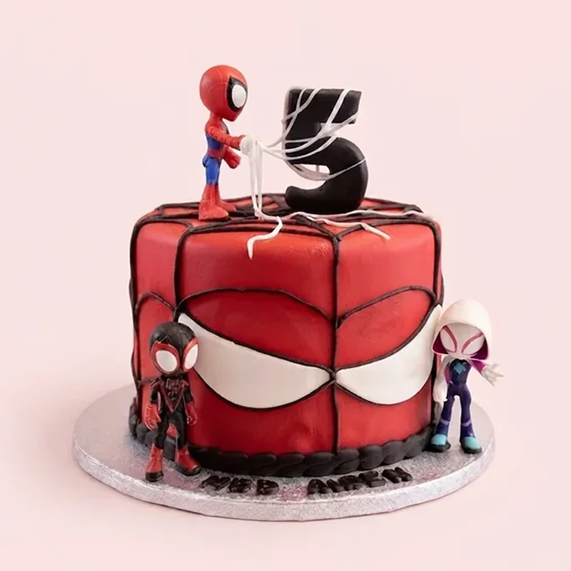 Red superhero web themed 5th birthday cake with mask motif and hero toppers by Cakeville Scarborough