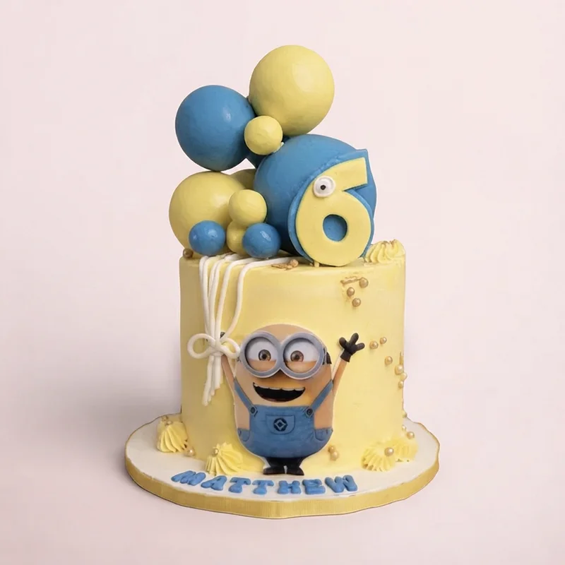 Yellow and blue birthday cake with fondant balloons and cartoon character by Cakeville Scarborough