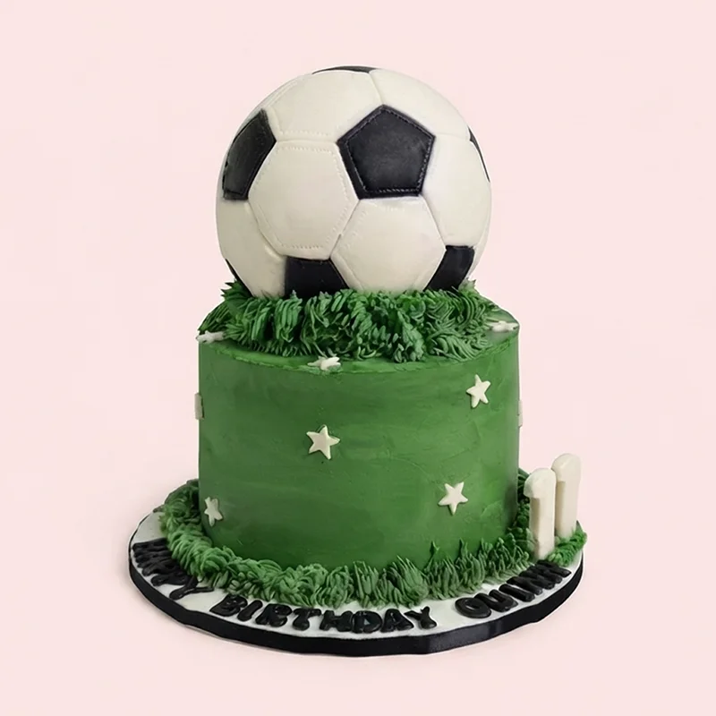 Green soccer themed birthday cake with 3D soccer ball topper and grass piping by Cakeville Scarborough